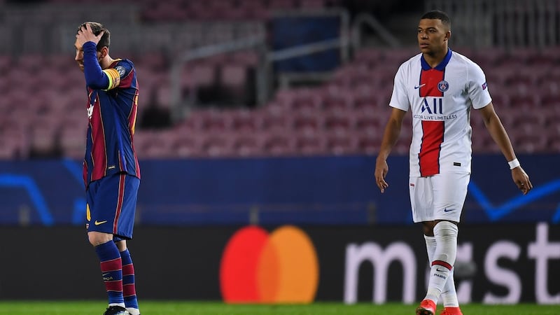Kylian Mbappe walks past a dejected Lionel Messi during PSG’s win over Barcelona. Photograph: David Ramos/Getty