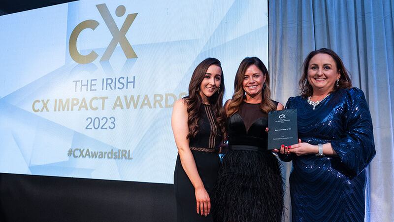 Rachael Corcoran, awards judge, presents the best innovation in CX award to Clódagh Moynihan and Lauren Woods, Oakview Early Years Services.