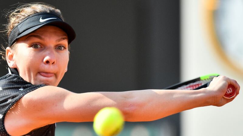 Romania’s Simona Halep eyes the ball as she returns it to Poland’s Iga Swiatek during their women’s singles fourth-round match at Roland Garros. Photograph: Martin Bureau/AFP/Getty Images