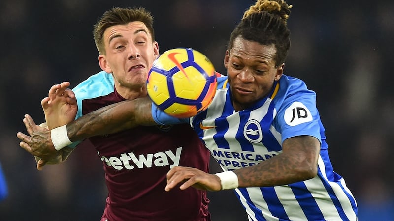 Brighton’s Cameroonian defender Gaetan Bong (R) in action against West Ham. Photograph: Glyn Kirk/AFP