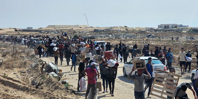 Displaced Palestinians walk along a road to receive humanitarian aid packages in Rafah in the southern Gaza Strip. Photograph: AFP via Getty Images
