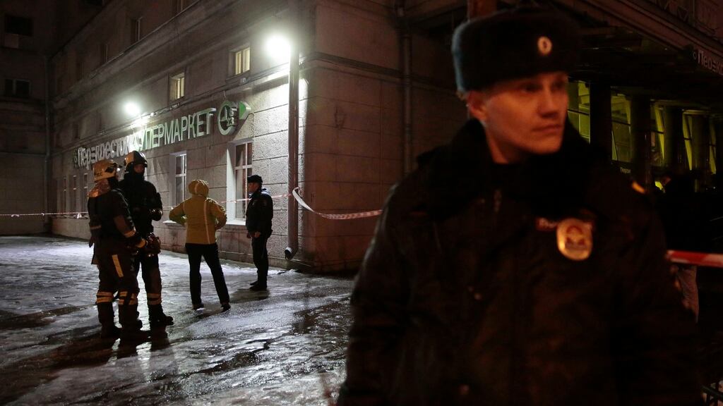 Emergency Ministry members and policemen outside a supermarket after an explosion in St Petersburg, Russia, today. Photograph: Anton Vaganov/Reuters