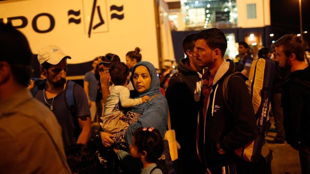 An Iraqi migrant woman and her son wait for a bus to take them to the train station after disembarking at the port of Piraeus near Athens on September 1st. Photograph: Win McNamee/Getty Images