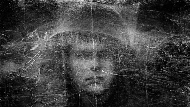 A soldier in Northern Ireland in 1973 is seen through a shield with dimmed visibility caused by repeated blows. Photograph: Philip Jones Griffiths / courtesy of Magnum Photos