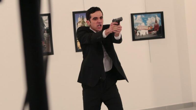 An unnamed gunman after shooting the Russian ambassador to Turkey, Andrei Karlov, at a gallery in Ankara, Turkey. Photograph: Burhan Ozbilici/AP Photo