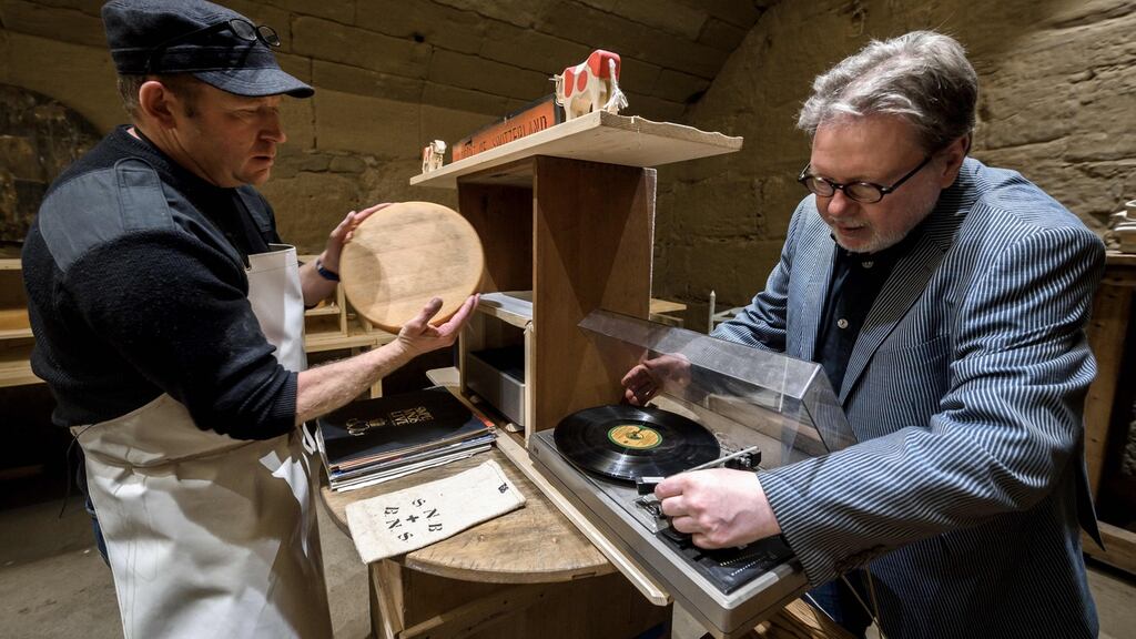 Swiss cheesemaker Beat Wampfler and director of the Music Department at University of the Arts in Bern, Michael Harenberg pose with a vinyl record and a wheel of Emmental. Photograph: Fabrice Coffrini/AFP/Getty Images