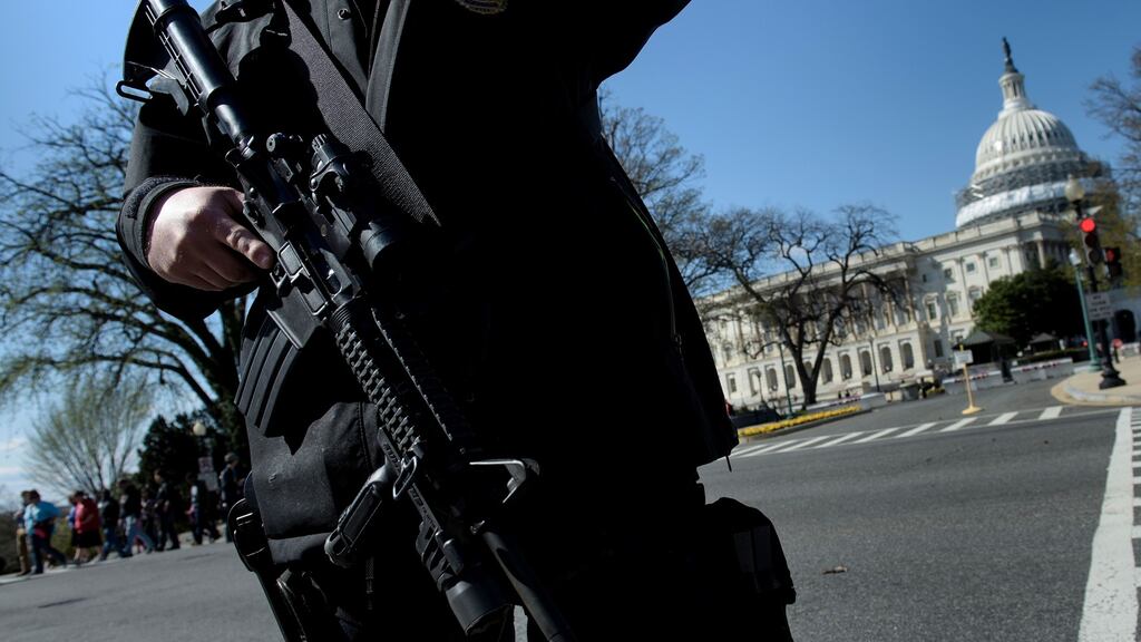 A police officer stands guard at the US Capitol complex in Washington, DC after reports of shots fired. Photograph: Brendan Smialowski/AFP/Getty Images