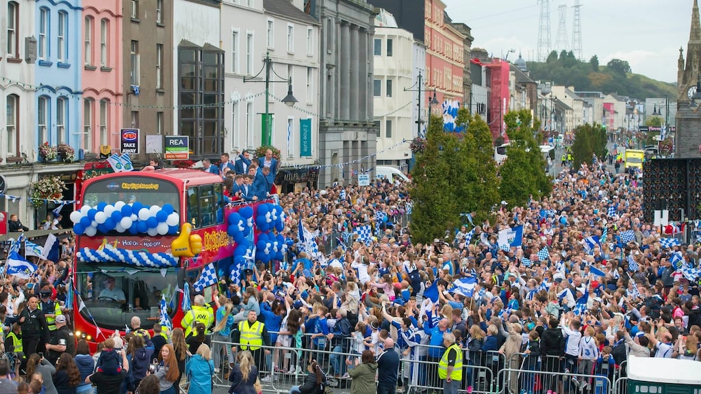 Waterford hurlers on board an open-topped bus are greeted by thousands of fans in the city on Monday evening. Photograph: Patrick Browne