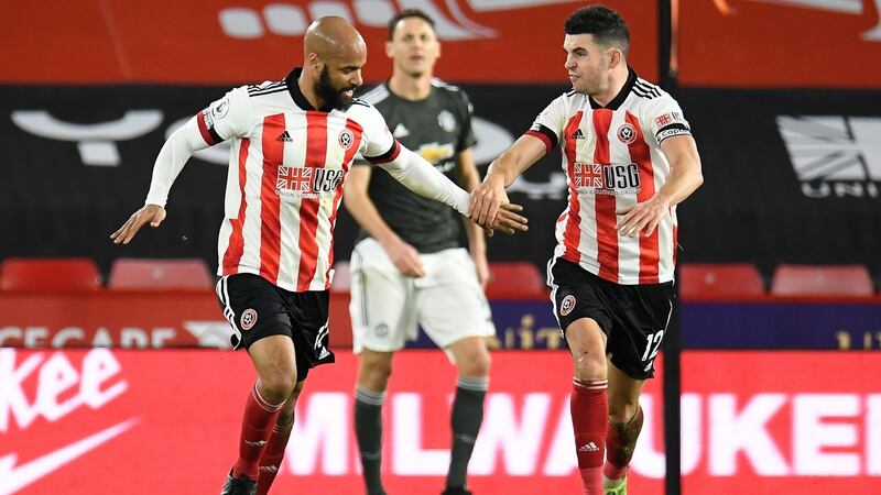 Sheffield United’s David McGoldrick is congratulated by team-mate John Egan after scoring during the Premier League game against Manchester United at Bramall Lane. Photograph: Peter Powell/EPA