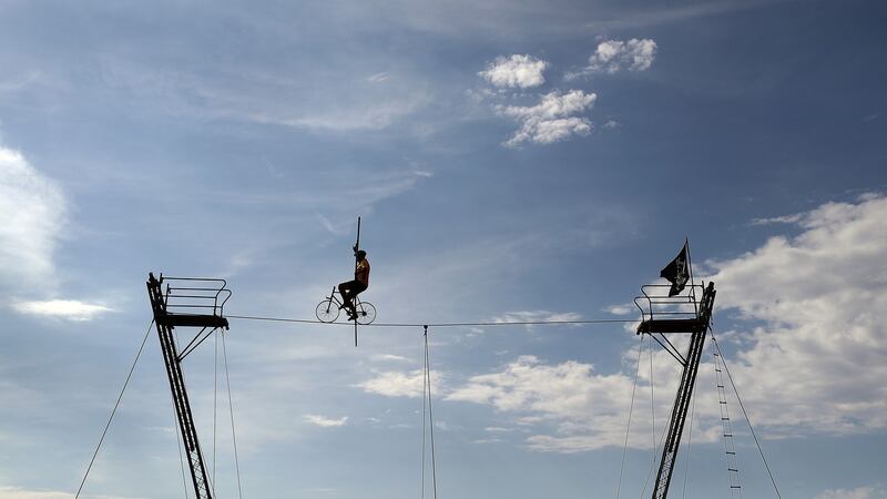 A high wire cyclist is seen on stage six of the Tour de France. Photograph: Bryn Lennon/Getty Images