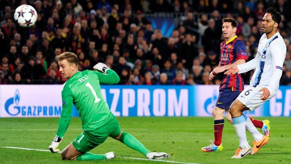 Lionel Messi of Barcelona flicks the ball past goalkeeper Joe Hart of Manchester City to score the opening goal at Camp Nou. Photograph: David Ramos/Getty Images