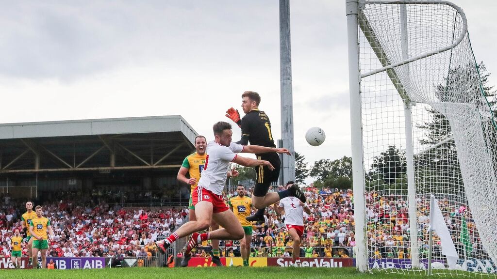 Tyrone’s Harry Loughran scores his side’s first goal despite Donegal goalkeeper Shaun Patton best efforts at MacCumhaill Park in Ballybofey. Photograph: Ryan Byrne/Inpho