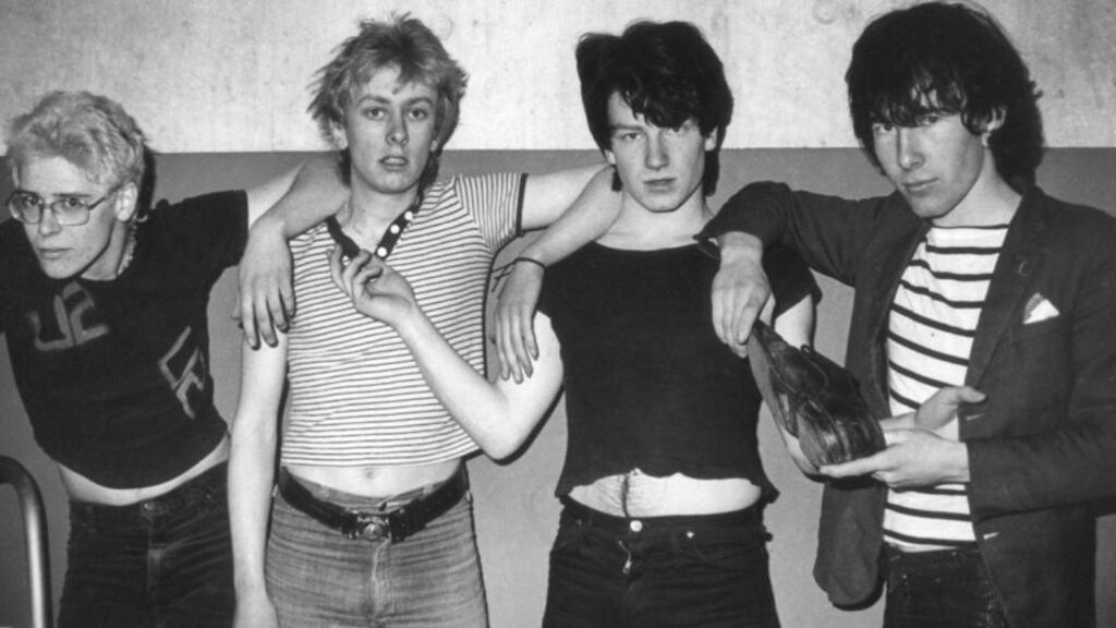 In their shoes: U2 at Trinity College in February 1979, with Guggi (second left) standing in for Larry Mullen jnr. Photograph: Patrick Brocklebank