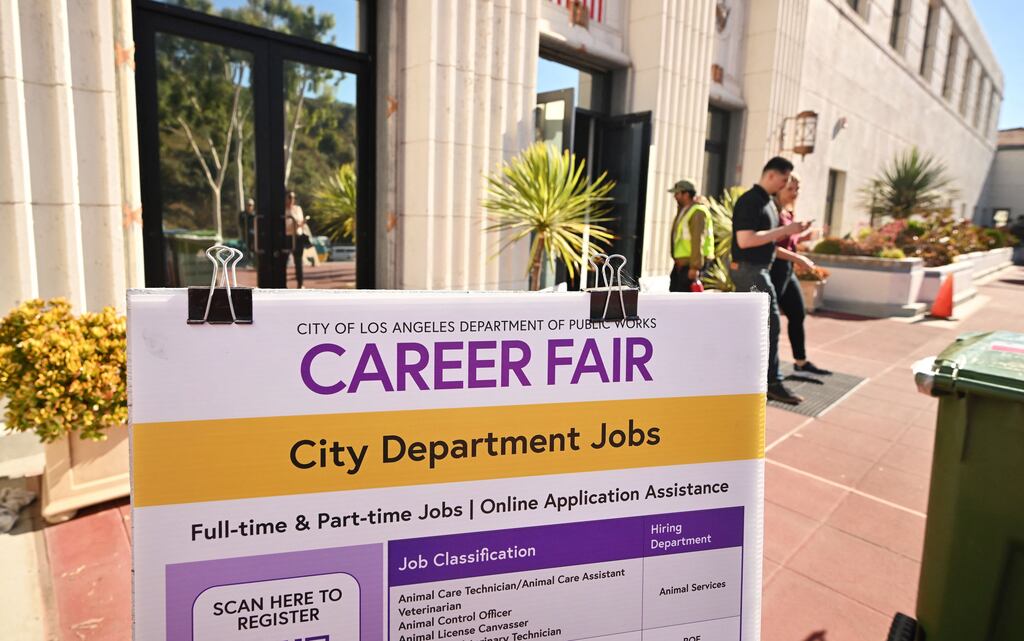 People enter and depart a career fair in Los Angeles. US job growth accelerated in September. Photograph: FREDERIC J. BROWN/AFP via Getty Images