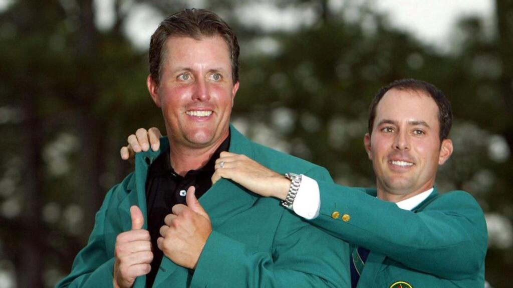 Phil Mickelson is presented with the green jacket in 2004 by the previous year’s Masters winner, Mike Weir. Photograph: Inpho/Getty