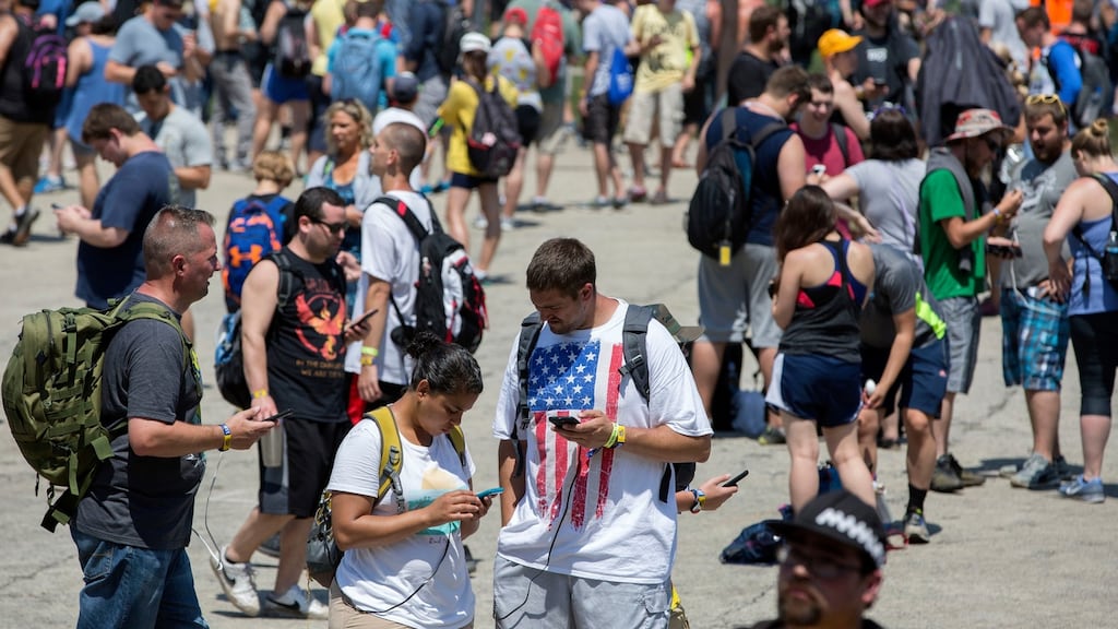 Festival goers wander the grounds at the Pokemon Go Fest Saturday in Chicago. Photograph: AP