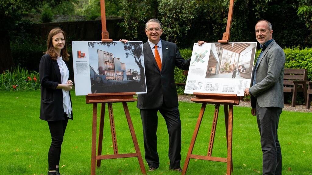 Competition winners Maria Mulcahy and Peter McGovern of Henry J Lyons Architects present their winning designs, alongside Department of Foreign Affairs secretary general Niall Burgess (centre)