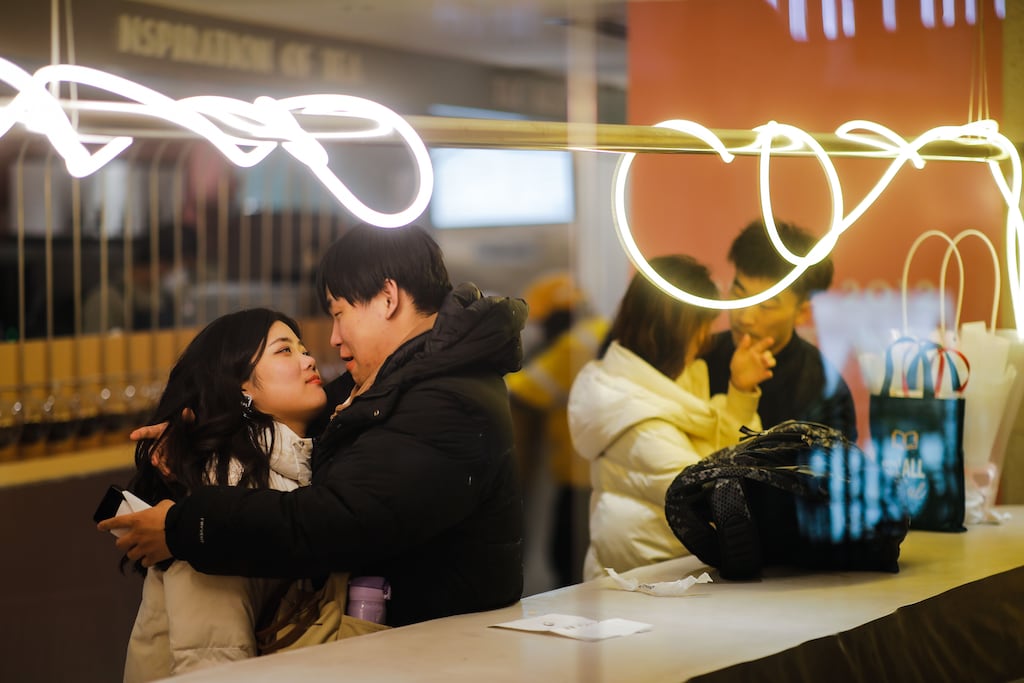 Couples in a shop at Solana shopping mall on Valentine's Day in Beijing. Photograph: Wu Hao/EPA