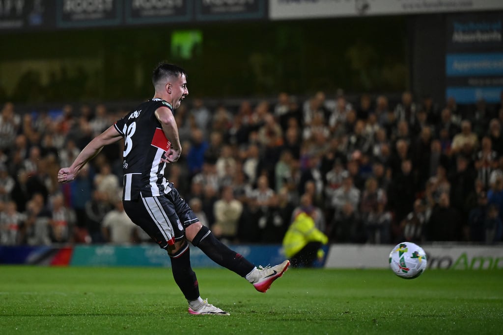 Darragh Burns scores for Grimsby during the penalty shoot-out against Manchester United at Blundell Park. Photograph: Shaun Botterill/Getty Images