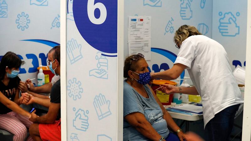 Israelis receive a dose of the Pfizer-BioNtech COVID-19 vaccine, at the Maccabi Health Service in Rishon Lezion, as Israel launches its campaign to give booster shots to people aged over 50, in a bid to stem spiking infections driven by the Delta variant. Photograph: Ahmad Gharabli/AFP
