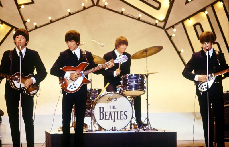 The Beatles's Paul McCartney, George Harrison, Ringo Starr and John Lennon performing on stage at a television studio in circa 1964. Photograph: Syndication/Mirrorpix/Mirrorpix via Getty Images