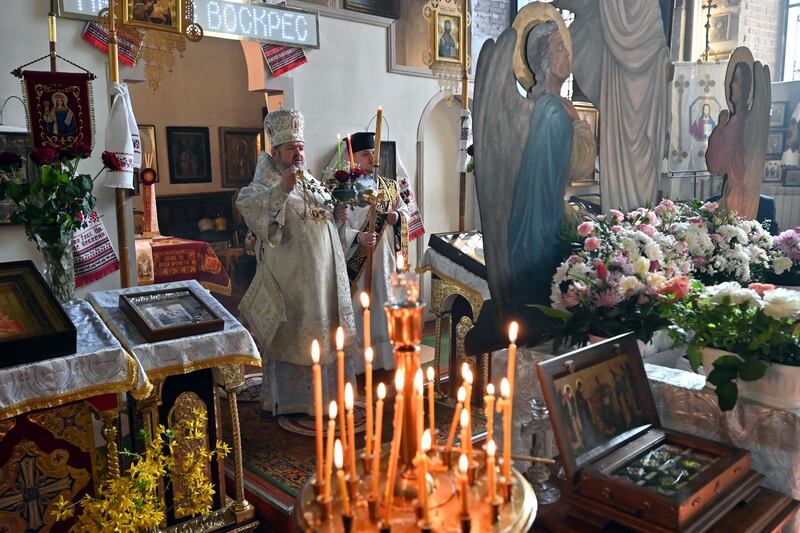 A priest conducts an Orthodox Easter service at the church of St John the Theologian in Kharkiv. Photographj: Sergey Bobok/AFP