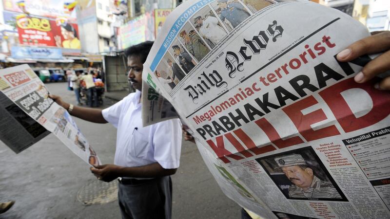 A man looks at a newspaper that details the end of the near four-decades long ethnic conflict in Colombo in May 2009. Photograph: Ishara S Kodikara/AFP via Getty Images