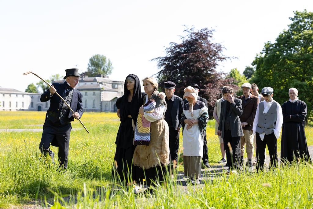 The bailiff, portrayed by John Kelly, with walkers in period costume participate in the eviction reenactment at the National Famine Museum at Strokestown Park, Co Roscommon. Photograph: Richie Stokes
