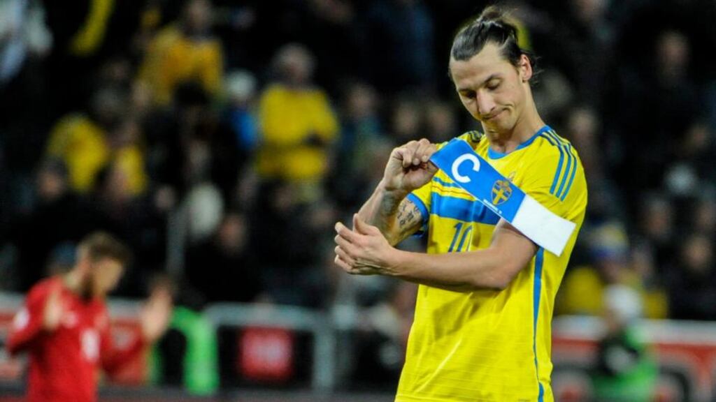 Sweden captain Zlatan Ibrahimovic takes off the armband after defeat to Portugal on Tuesday night. Photograph: Erik Martensson/EPA