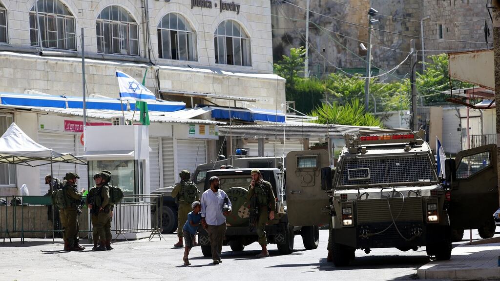 Israeli troops in Hebron near where a Palestinian woman was shot dead after police said she brandished a knife near a contentious holy site. Photograph: Abed Al Hashlamoun/EPA