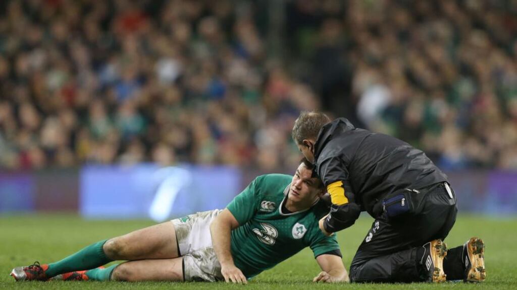 Jonathan Sexton down injured and receiving attention during last Saturday’s rugby international against Australia. Photograph: Colm O’Neill/Inpho