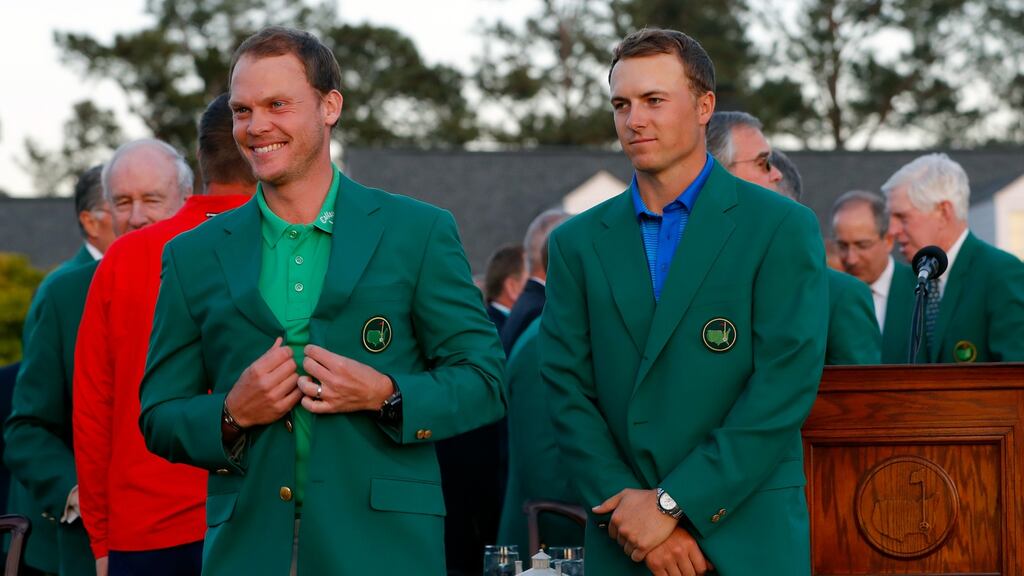 Jordan Spieth stands dejected after presenting 2016 Masters champion Danny Willett with the green jacket. Spieth let his lead slip after a quadruple bogey seven on the 12th hole at Augusta National. Photo: Kevin C Cox/Getty Images