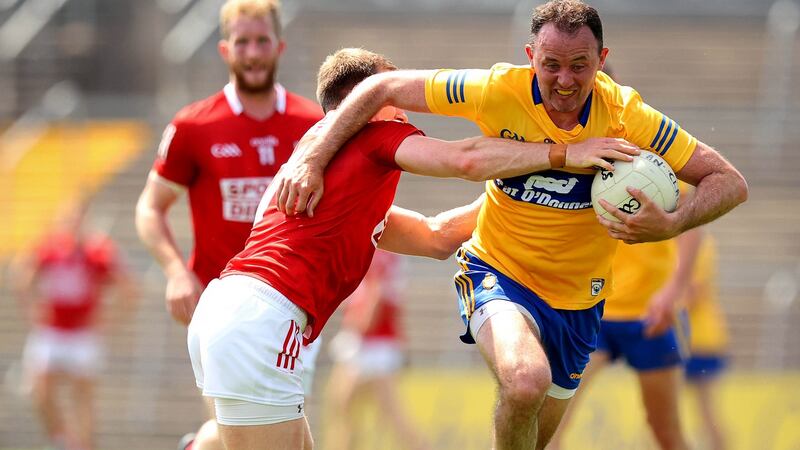 Clare’s David Tubridy is challenged by Mattie Taylor of Cork during the Allianz Football League Division 2 South game at Cusack Park in Ennis. Photograph: Ryan Byrne/Inpho