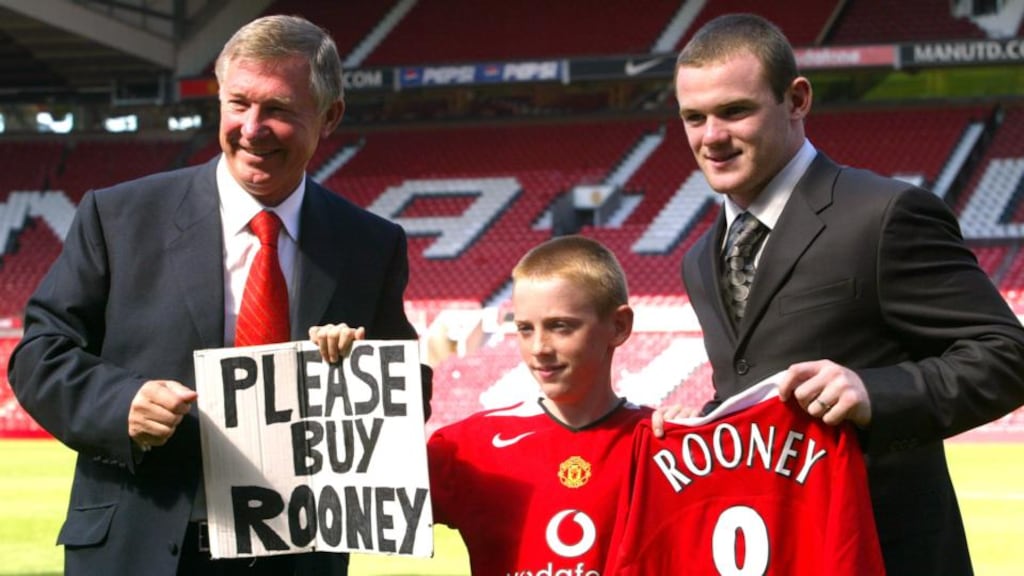 A photo from 2004 with Manchester United manager Alex Ferguson and Wayne Rooney with Joe Ruane (centre) who held a sign pleading for the club to sign Wayne Rooney. Photograph: Gareth Copley/PA Wire.
