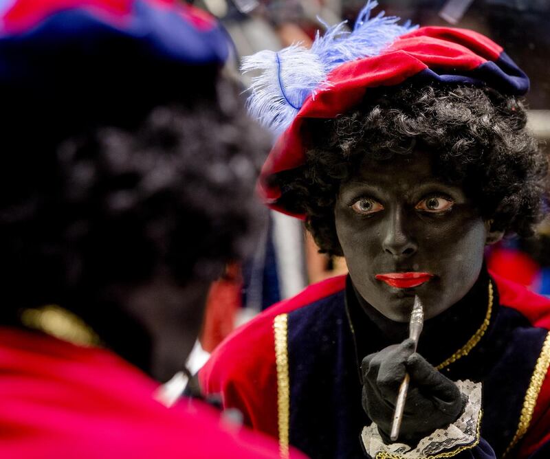 A woman has her face painted to become Zwarte Piet (Black Pete). Photograph: Robin Van Lonkhuijsen/AFP via Getty Images