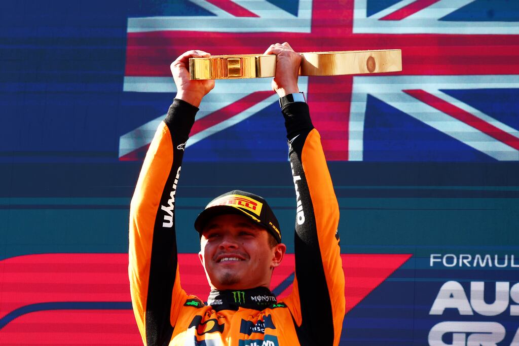 Race winner Lando Norris lifts his trophy on the podium during the F1 Grand Prix of Austria. Photograph: Joe Portlock/Getty