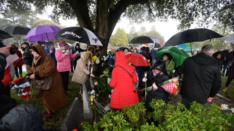 Visiting graves on a rain-drenched afternoon at Glasnevin Cemetery during the eighth annual Flowers for Magdalenes memorial event. Photograph: Dara Mac Dónaill/The Irish Times