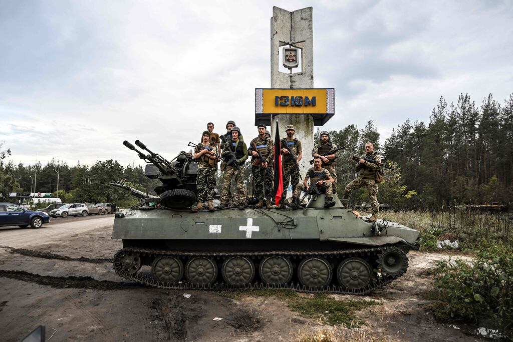 Soldiers pose outside of Izyum, eastern Ukraine, on Saturday amid the Russian invasion of Ukraine. Photograph: Juan Barreto/AFP/Getty Images