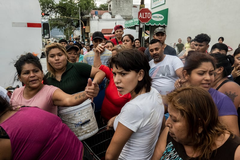 Residents of the Industrial neighborhood wait to fill their containers with water in Monterrey. Photograph: Cesar Rodriguez/New York Times