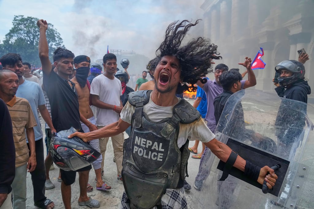 A protester wearing a flak jacket and carrying a shield snatched from a policeman during the recent protests in Kathmandu, Nepal. Photograph: Niranjan Shrestha/AP