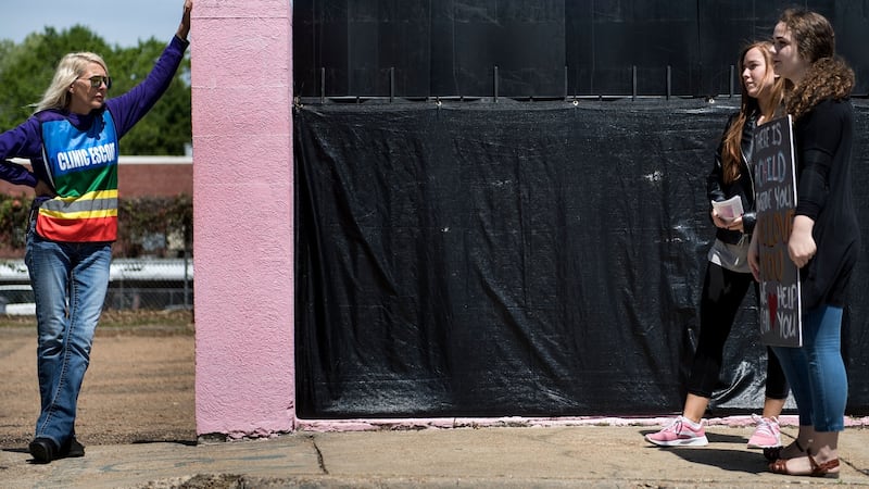 A volunteer, left, who escorts patients into the Jackson Women’s Health Organisation, and pro-life activists wait for patients to arrive. Photograph: Brendan Smialowski/AFP via Getty