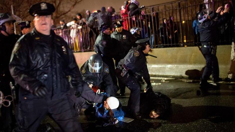 Police arrest protesters   along FDR Drive in Manhattan in New York City as thousands of demonstrators took to the streets of New York demanding justice for the death of Eric Garner. Photograph: Eric Thayer/Reuters