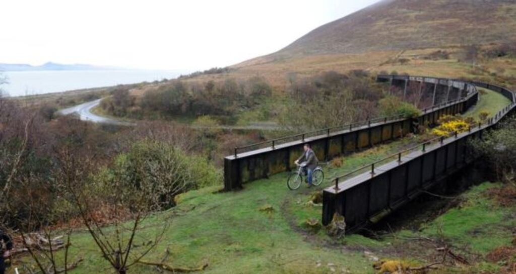 Then minister of state for transport Alan Kelly cycling on the old Glenbeigh to Caherciveen railway line after he launched the greenway in 2014. File photograph: Don MacMonagle