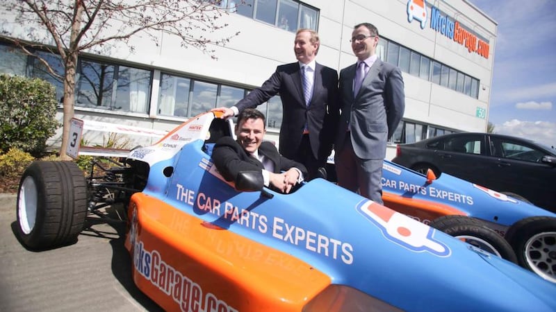 Taoiseach Enda Kenny with Ciaran and Michael Crean at the opening of MicksGarage.com headquarters in Park West, Dublin. Their business began life in a bedroom in 2004. Now it’s an €11 million turnover company employing 48 people. Photograph: Conor McCabe Photography