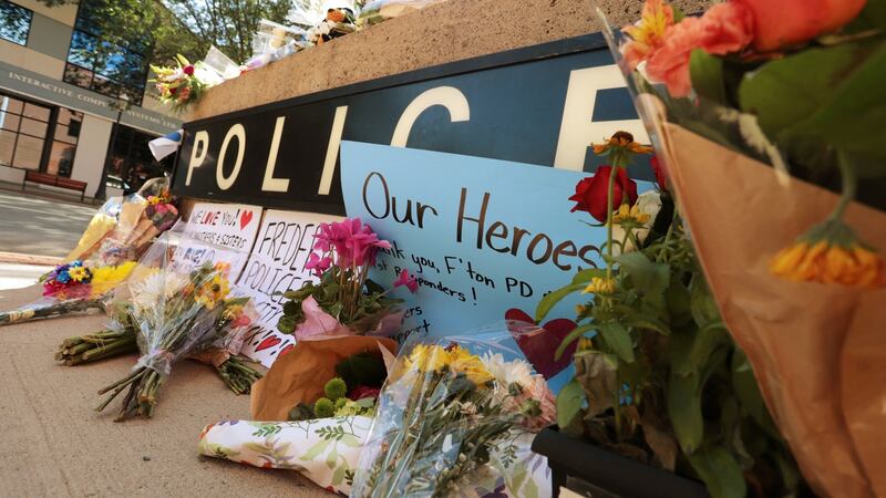 A makeshift memorial has been forming outside police headquarters in Fredericton, New Brunswick, Canada. Photograph: Reuters