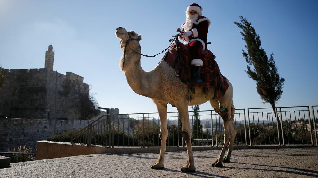 Israeli-Arab Issa Kassissieh during the annual Christmas tree distribution by the Jerusalem municipality in the Old City on December 20th: Rabbi’s issued a statement to remind hoteliers that erecting a Christmas tree in a hotel contravenes Jewish law. Photograph: Amir Cohen/Reuters