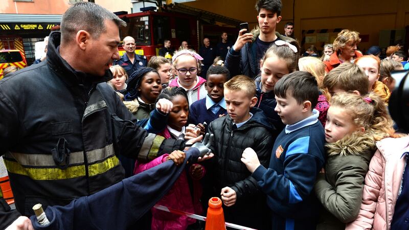 Phil Kelly of Dublin Fire Brigade show children from Clonburris NS, Clondalkin, the dangers of fireworks at the launch of its Be Safe – Stay Safe Halloween Campaign. Photograph: Dara Mac Dónaill