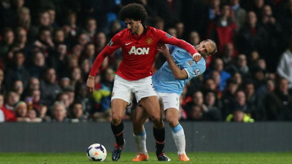 Manchester United’s Marouane Fellaini elbows Manchester City’s Pablo Zabaleta during the Premier League match at Old Trafford. Photograph: Peter Byrne/PA
