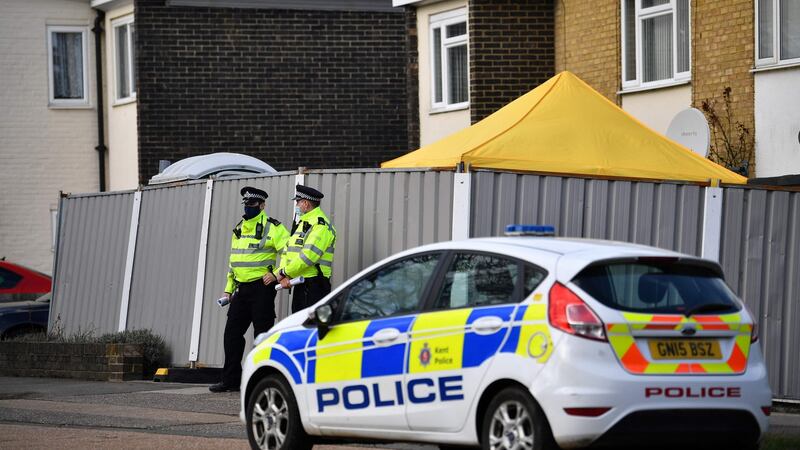 Police officers stand guard at a temporary police barrier around the home of a murder suspect in Deal, Kent. Photograph: Ben Stansall/AFP via Getty