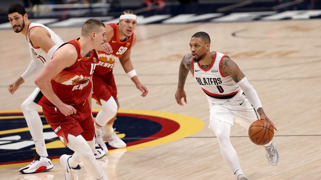 Nikola Jokic closes down Damian Lillard during Denver’s Game 2 win over Portland. Photograph: Matthew Stockman/Getty